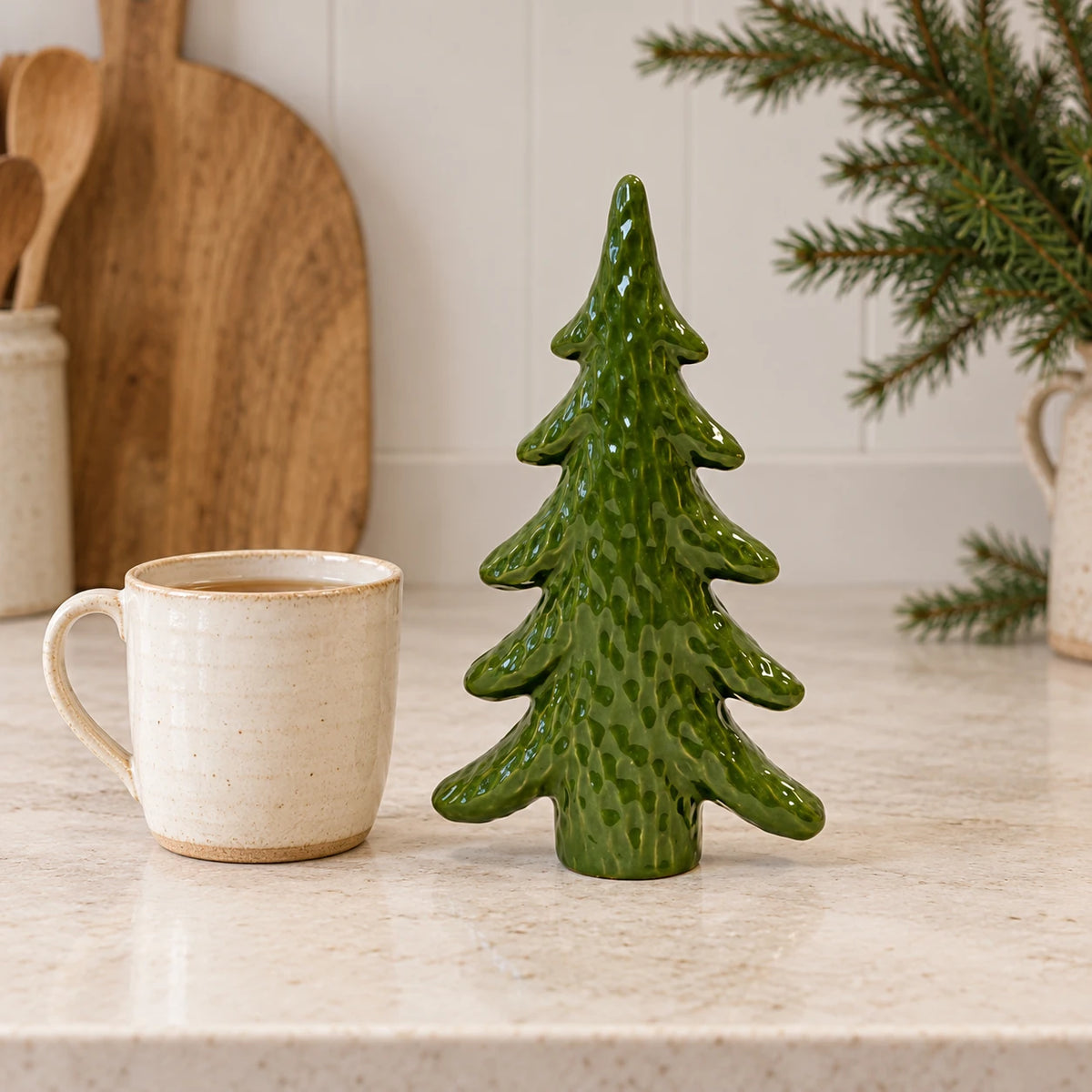 Green ceramic Christmas tree ornament by Satchville displayed on a kitchen scale