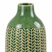 medium green ceramic vase close-up showing glossy green glaze and cream leaf-patterned detailing on white