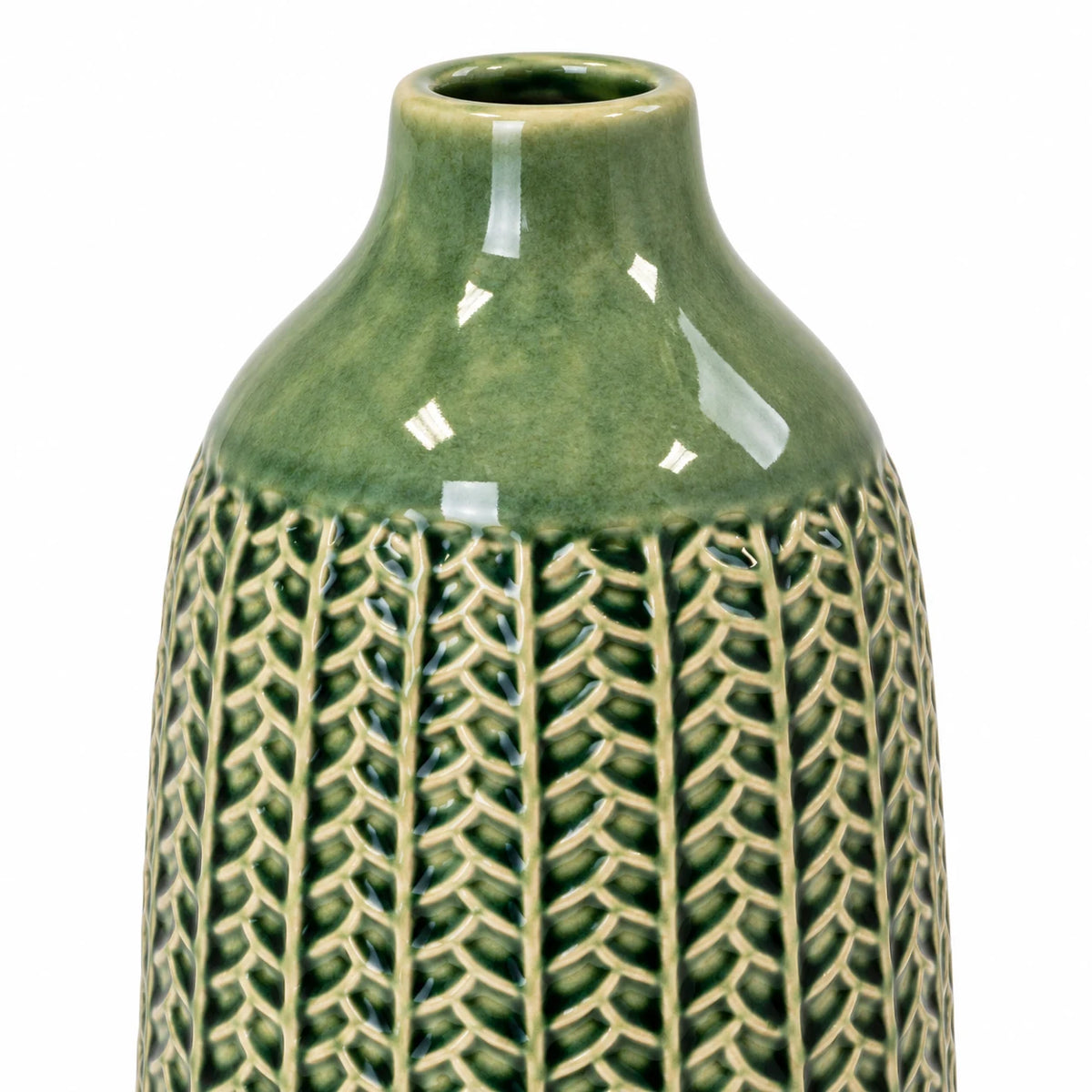 small green ceramic vase close-up showing glossy green glaze and cream leaf-patterned detailing on white