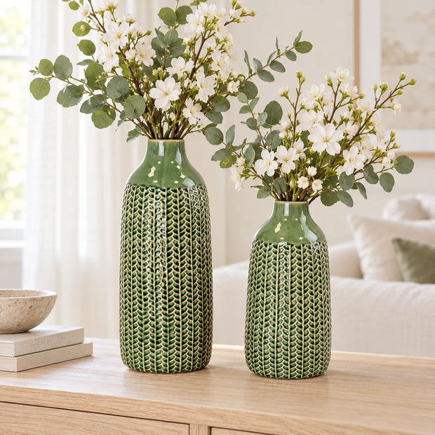Small 29cm and medium 38cm green ceramic vases with white flowers, shown together for size comparison; sold separately