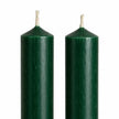 Close-up of the rustic green wax finish and unlit wicks on two dinner candles.