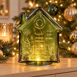 Green LED glass gingerbread house for Christmas décor, illuminated with festive green lights by Candlelight Products Ltd.
