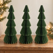 Three matching 30 cm green paper Christmas trees side by side on an oak console.