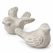 Close-up of the grey stone birds showing sculpted wing feathers and a distressed pale grey finish.