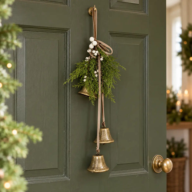 Christmas hanging bells decorated with greenery and white berries, perfect for door decor by Satchville