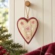 Floral wooden red heart hanging from an oak peg against cream panelling