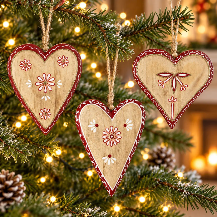 Three assorted wooden red heart designs on a Christmas tree; sold individually with design selected at random