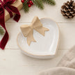 White ceramic heart dish styled flat with a burgundy ribbon gift for Christmas