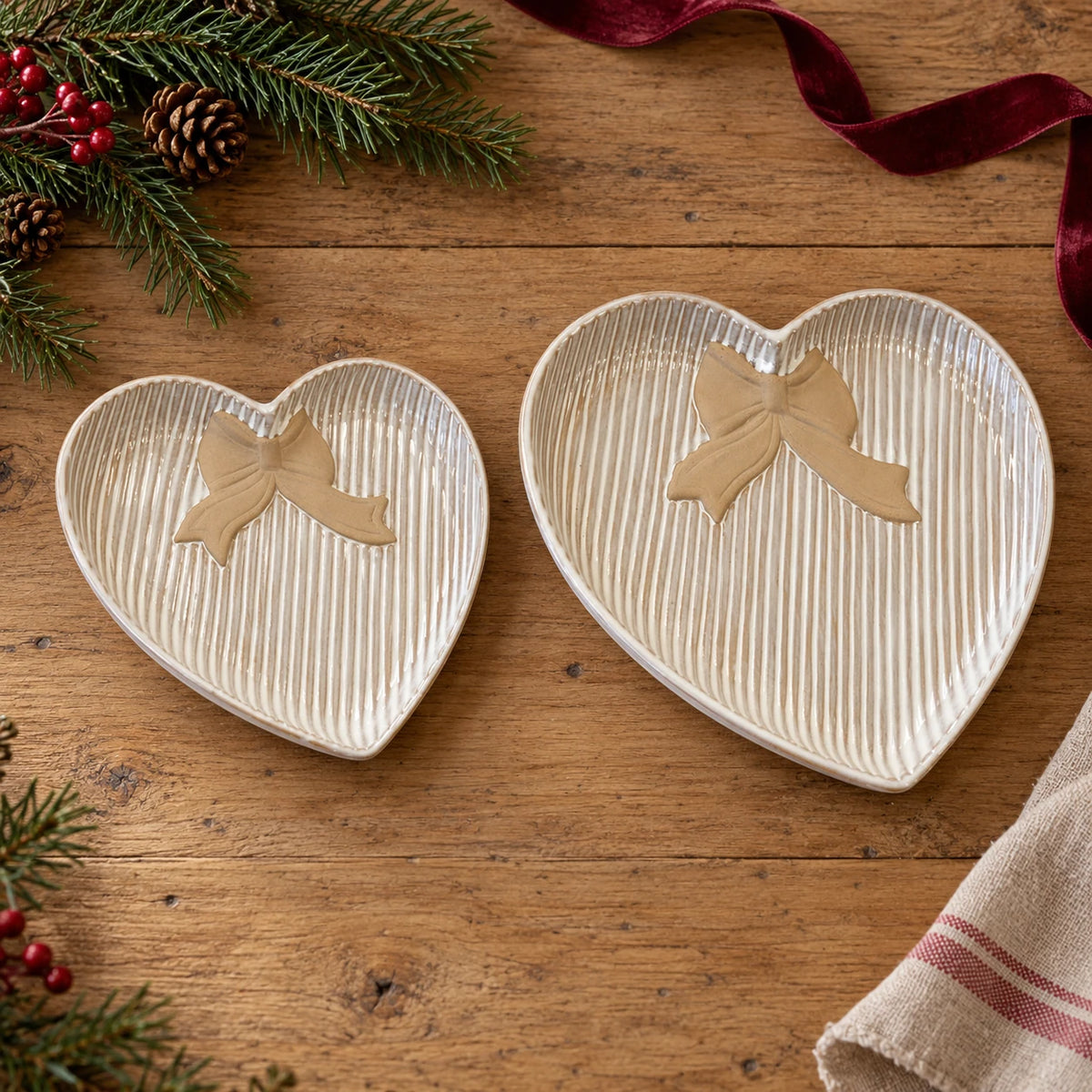 Satchville large heart plate with bow detail, shown alongside small plate in Christmas setting