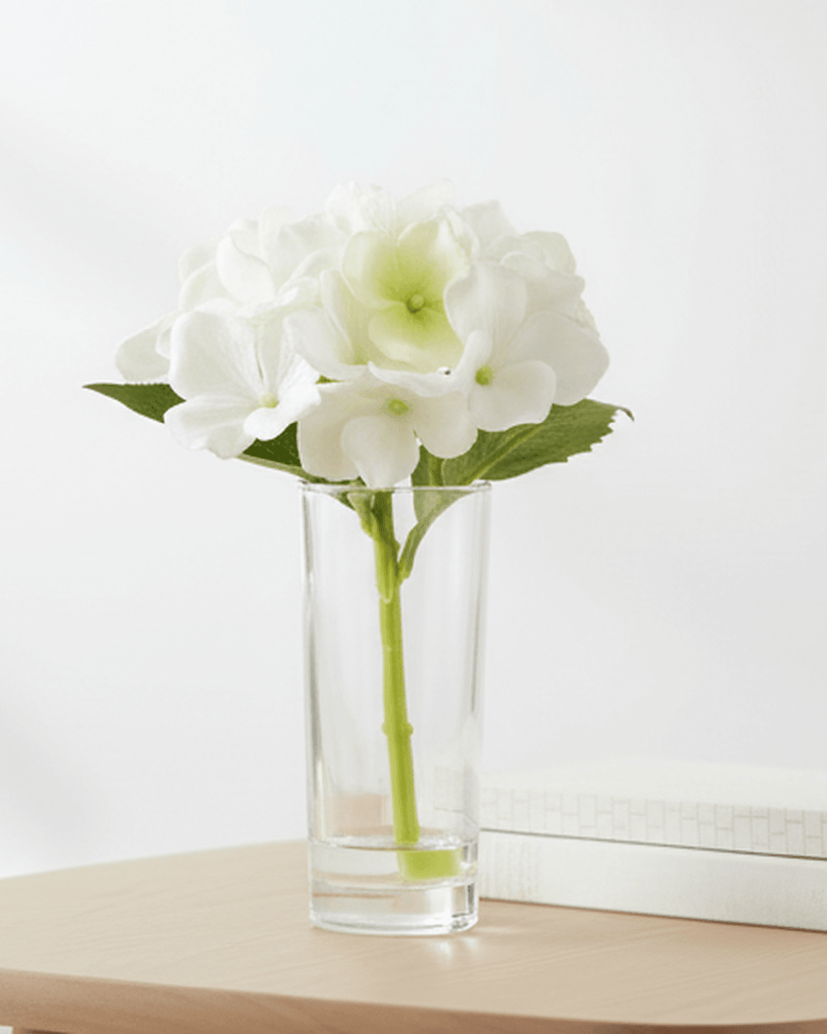 Artificial Mini White Hydrangea Stem In A Glass Bud Vase
