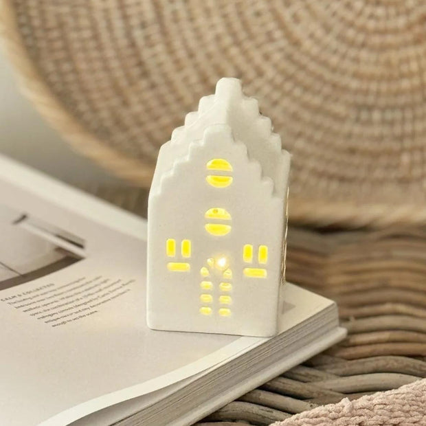 Beige ceramic Christmas house with LED lights by Heaven Sends, perfect holiday decor with a festive glow.