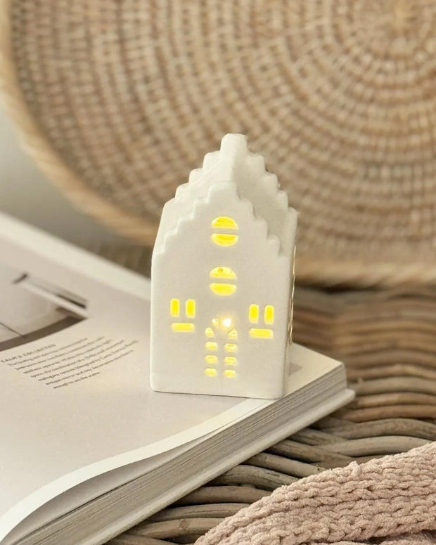 Beige ceramic Christmas house with LED lights by Heaven Sends, perfect holiday decor with a festive glow.