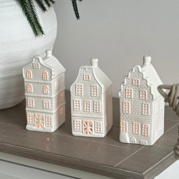 Matte White Dutch House Tealight Candle Holder, three white Dutch house tealight holders on a cabinet