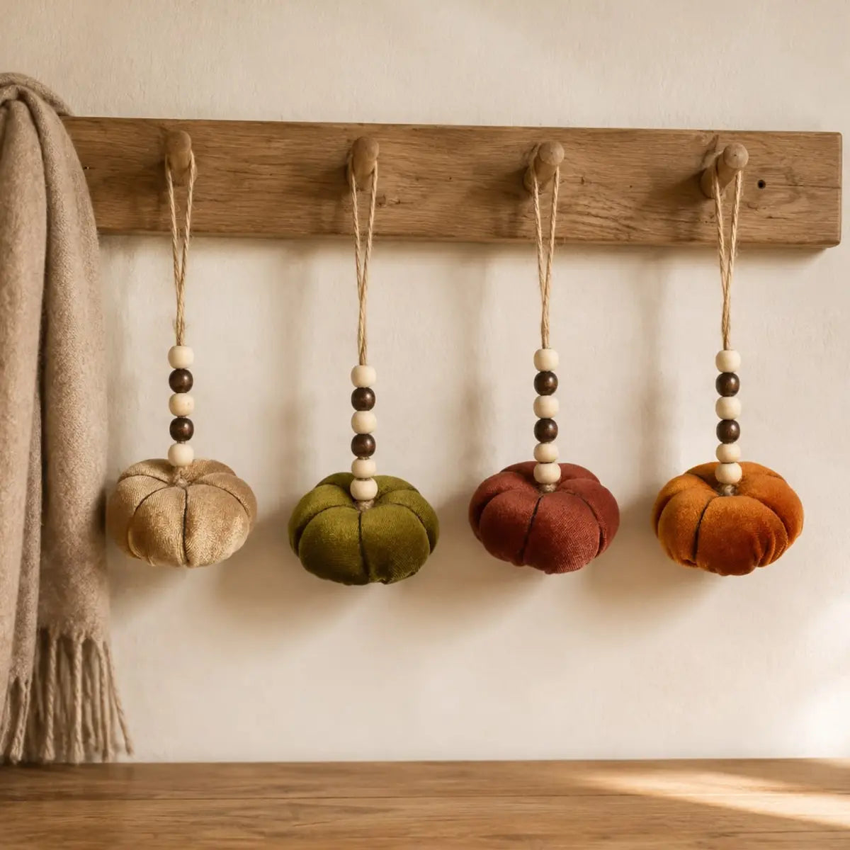 Velvet pumpkins with bead hangers, autumn decor by Heaven Sends, featuring soft fabric pumpkins with decorative bead accents.
