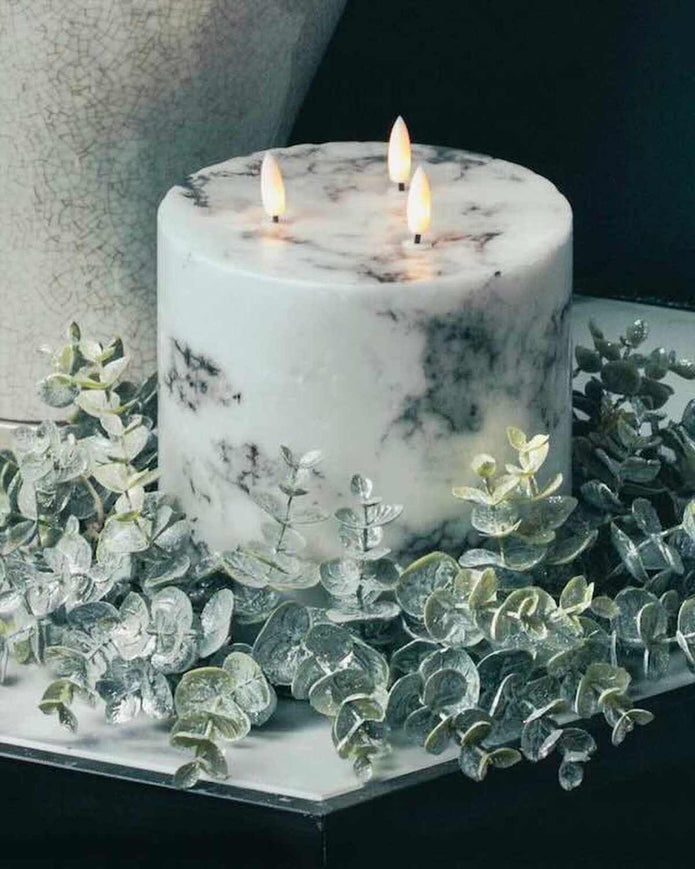 Frosted eucalyptus candle wreath styled around a marbled LED pillar candle; candle not included.
