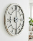 White medium round wooden Williston wall clock by Hill Interiors, showing a minimalist design with black hour and minute hands.