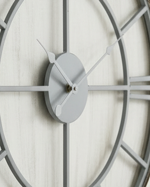 White medium round wooden Williston wall clock by Hill Interiors, featuring a sleek design and classic clock face.
