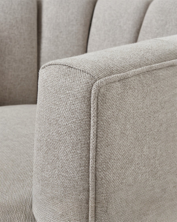 Beige Lily swivel linen arm chair by Hill Interiors, showcasing a comfortable upholstered chair with a rounded back and armrests.