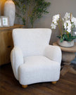 Greige Hill Interiors Hui large arm chair with plush cushioning and wooden legs, modern furniture piece for living rooms.