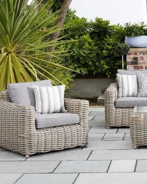 Rattan Amalfi outdoor five-seater garden furniture set with chairs and table, designed for outdoor patio relaxation.