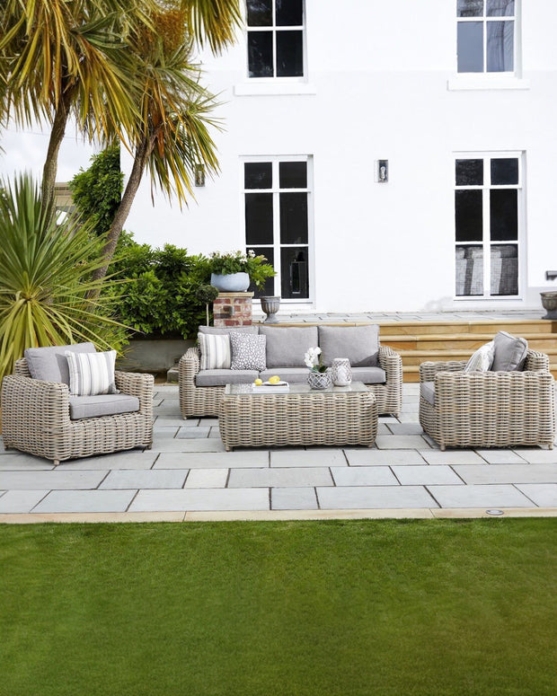 Rattan Amalfi outdoor five-seater garden furniture set with chairs and table by Hill Interiors for outdoor dining and relaxing.
