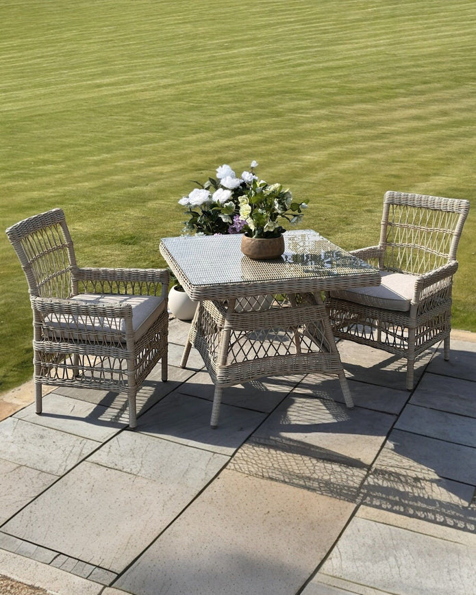 Rattan Provence Collection outdoor 4-seater dining set by Hill Interiors, garden furniture with wicker chairs and table for patio.