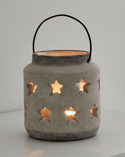 Stone star hurricane lantern for home decor by Hill Interiors, featuring a rustic stone design and glass hurricane for ambient lighting.