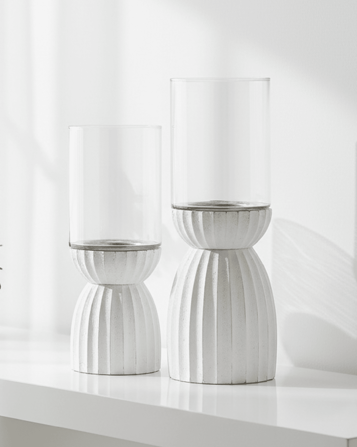 White carved hurricane lantern for home decor, featuring intricate design and sturdy glass, ideal for stylish interior accents.