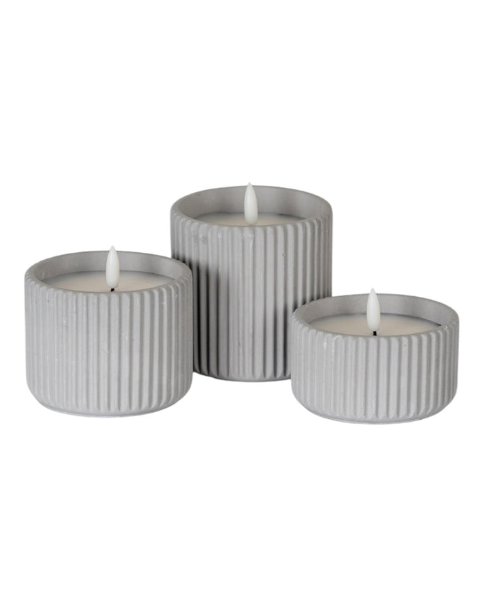 Natural stone ribbed LED candle from Hill Interiors, illuminated home decor piece with a textured, ribbed design and soft lighting.