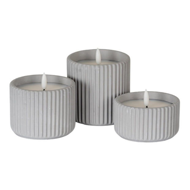 Natural stone ribbed LED candle from Hill Interiors, illuminated home decor piece with a textured, ribbed design and soft lighting.