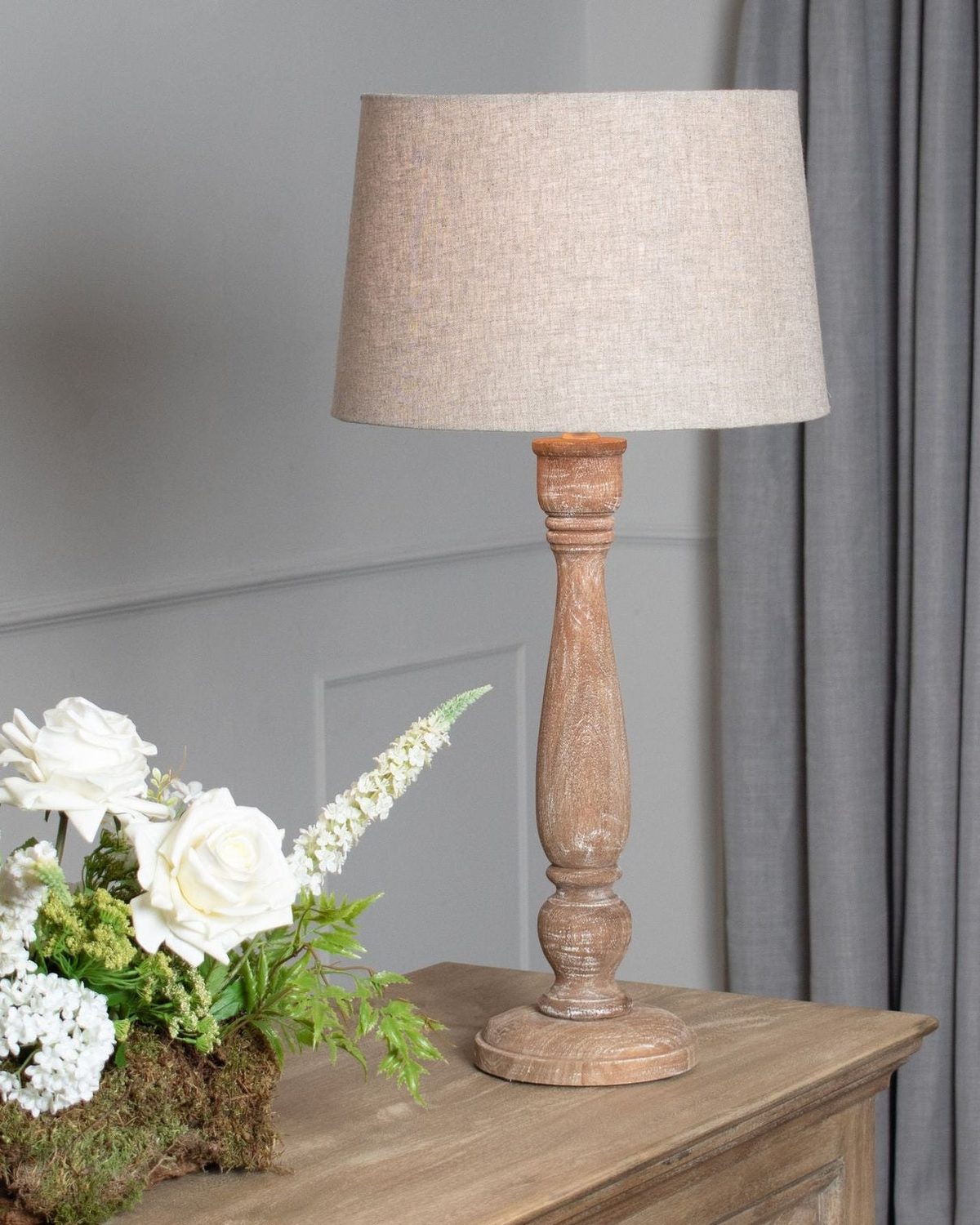 Delaney candlestick lamp by Hill Interiors, 70cm tall with natural wash wood finish and linen shade, ideal for living room lighting.