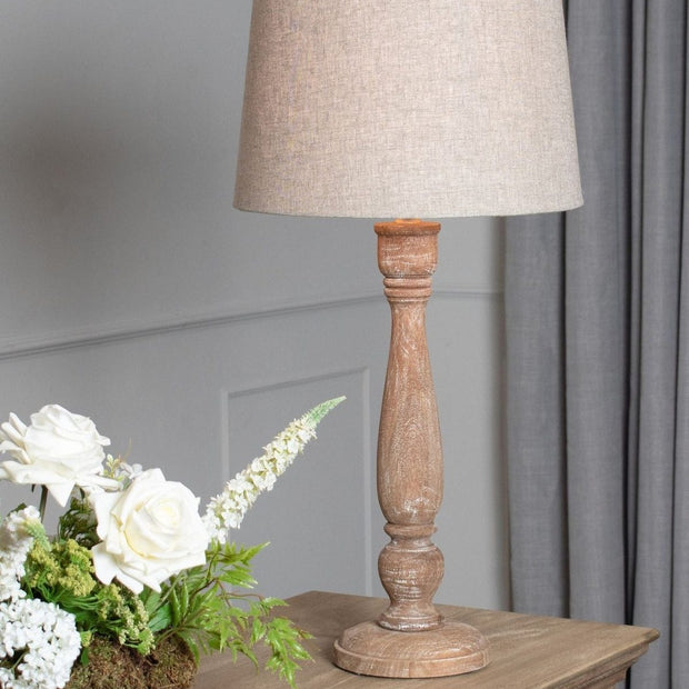 Delaney candlestick lamp by Hill Interiors, 70cm tall with natural wash wood finish and linen shade, ideal for living room lighting.