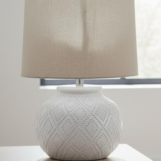 White beaded ceramic lamp by Hill Interiors, squat-shaped lighting fixture with textured surface and decorative design.