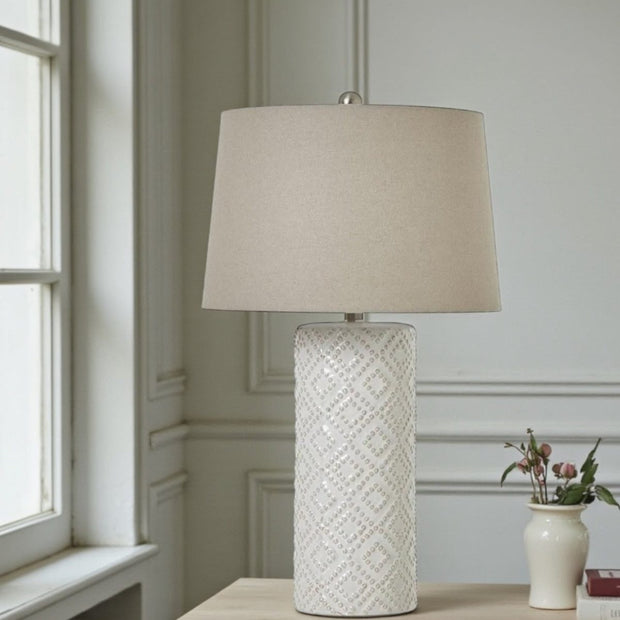 Tall white beaded ceramic lamp with linen shade, decorative lighting piece by Hill Interiors for elegant interior decor.