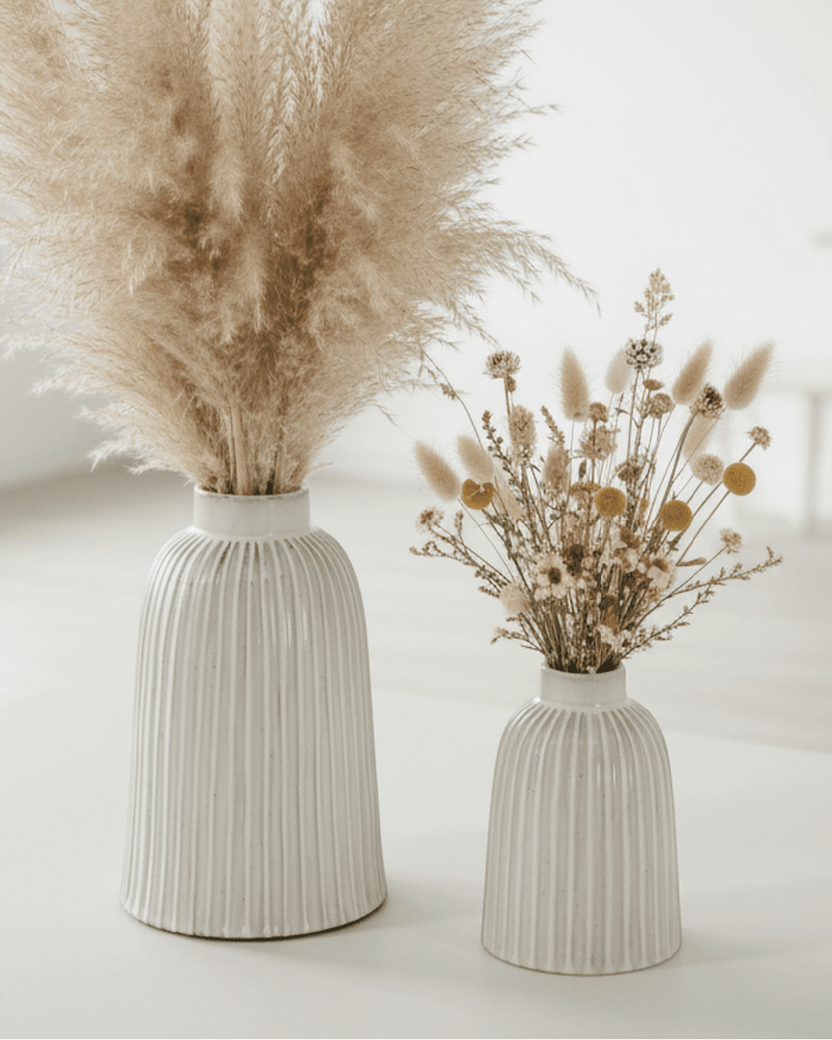 Medium Monte ribbed vase by Hill Interiors, showcasing a textured ceramic design with a neutral finish.
