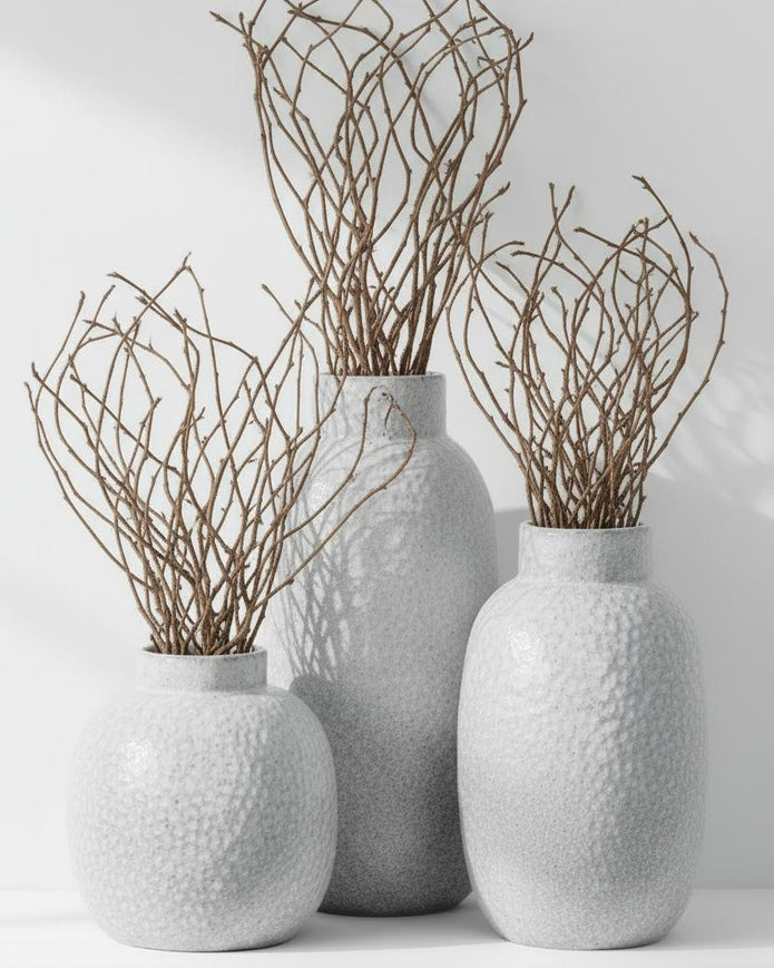 White glazed Cairn Dimple vase by Hill Interiors, ceramic vase with textured dimple design and smooth glossy finish.