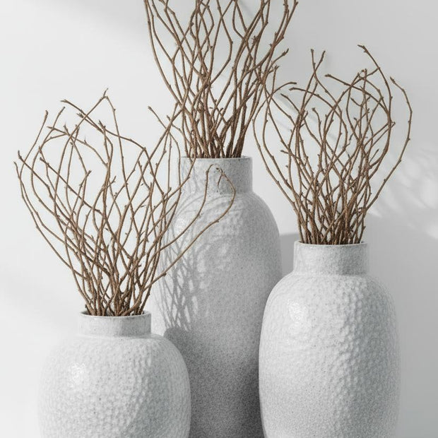 White glazed Cairn Dimple vase by Hill Interiors, ceramic vase with textured dimple design and smooth glossy finish.