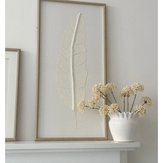 Large white feather print wall art in a frame by Hill Interiors, showcasing elegant feather design for home decor.