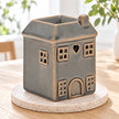 Widdop & Co grey ceramic house shaped wax melt burner on a spring dining table