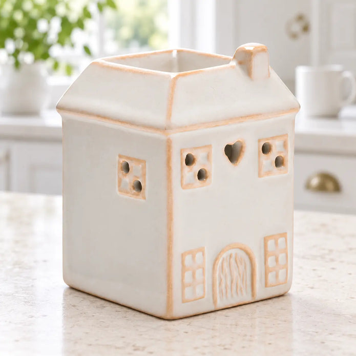 White ceramic house-shaped wax melt burner by Widdop & Co in a spring kitchen setting