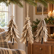 Neutral and brown felt hanging tree decorations styled together on fir