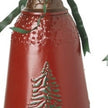 Close-up of red metal bell with green Christmas tree motif, bronze scalloped rim and green bow