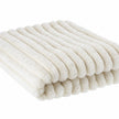 Close-up of the ivory throw's fluffy faux fur fibres and raised ribbed texture