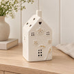 Large 17cm ivory ceramic LED house with raised flowers and gold-coloured details, console view, LED switched off.