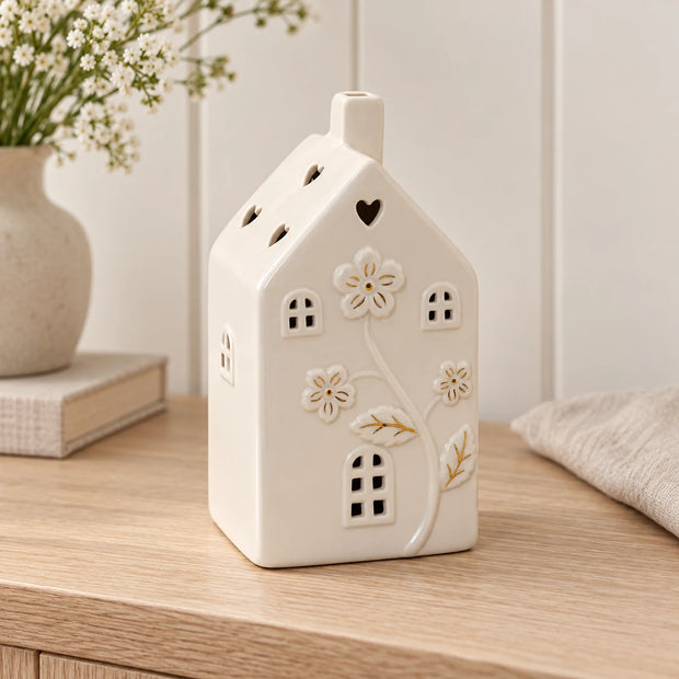 Large ivory ceramic house with LED floral lights, decorative home decor piece by Satchville featuring intricate floral details.