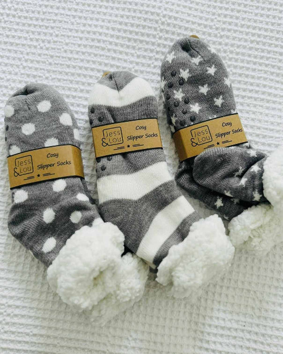 Grey spotted cozy slipper socks by Jess & Lou, soft and warm accessories for comfortable indoor wear.
