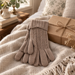 Oatmeal cable knit gloves styled beside a kraft gift box