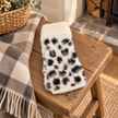 Cream leopard fingerless gloves on a rustic country bench