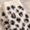 Close-up of cream black and tan fluffy leopard knit