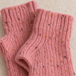 Close-up of the pink speckled rib knit glove texture